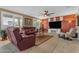 Cozy living room featuring comfortable seating, a ceiling fan, and bright windows with plantation shutters at 18187 E Via Jardin --, Gold Canyon, AZ 85118