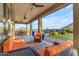 Inviting covered patio with comfortable seating, ceiling fans, and a view of the pool and backyard at 18187 E Via Jardin --, Gold Canyon, AZ 85118