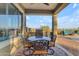 Outdoor dining area on the covered patio featuring a grill, mini fridge, and wrought iron chairs at 18187 E Via Jardin --, Gold Canyon, AZ 85118