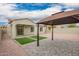 Backyard featuring a gazebo, artificial turf, and a covered patio, perfect for outdoor relaxation and gatherings at 1827 S 237Th Dr, Buckeye, AZ 85326