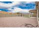 Expansive backyard with gravel, a gazebo, covered patio, and privacy wall, perfect for outdoor activities at 1827 S 237Th Dr, Buckeye, AZ 85326