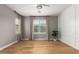 Empty bedroom with hardwood floors, natural lighting, a ceiling fan, and stylish window coverings at 1827 S 237Th Dr, Buckeye, AZ 85326