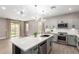 Modern kitchen featuring gray cabinets, stainless steel appliances, a spacious island, and stylish pendant lighting at 1827 S 237Th Dr, Buckeye, AZ 85326