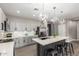 Bright kitchen featuring gray cabinets, subway tile backsplash, stainless steel appliances, and a large center island at 1827 S 237Th Dr, Buckeye, AZ 85326