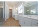 Bathroom featuring dual vanities, large mirror, and walk-in shower at 1910 E Empeltre Rd, San Tan Valley, AZ 85140