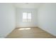 Well-lit bedroom with a window and light wood-look flooring at 1910 E Empeltre Rd, San Tan Valley, AZ 85140