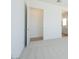 Bedroom with gray carpeting, open door, and bath access at 1910 E Empeltre Rd, San Tan Valley, AZ 85140