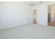 Spacious bedroom with gray carpeting and adjacent bathroom at 1910 E Empeltre Rd, San Tan Valley, AZ 85140