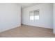 Sunlit bedroom with light wood-look flooring and white trim at 1910 E Empeltre Rd, San Tan Valley, AZ 85140