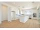 Bright kitchen featuring stainless steel appliances, an island, and white cabinetry, with plank flooring at 1910 E Empeltre Rd, San Tan Valley, AZ 85140