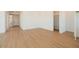 Bright living room featuring plank flooring, white walls, and access to the pantry at 1910 E Empeltre Rd, San Tan Valley, AZ 85140