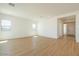Bright living room featuring plank flooring, white walls, and bright recessed lighting at 1910 E Empeltre Rd, San Tan Valley, AZ 85140