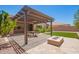 Backyard patio with pergola, fan, dining set and adjacent artificial turf at 19740 W Sherman St, Buckeye, AZ 85326