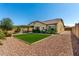 This spacious backyard with synthetic lawn, patio, and desert landscaping creates a relaxing and inviting outdoor oasis at 19740 W Sherman St, Buckeye, AZ 85326