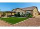 Home backyard featuring artificial turf, patio area, and desert landscaping is perfect for outdoor entertaining at 19740 W Sherman St, Buckeye, AZ 85326