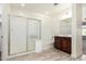 Spacious bathroom with a glass shower, vanity, tub, and tile flooring at 19740 W Sherman St, Buckeye, AZ 85326