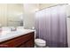 Cozy bathroom with a vanity, toilet, and a shower curtain at 19740 W Sherman St, Buckeye, AZ 85326