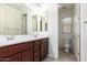 Bathroom with a double vanity, mirror, and a separate toilet room at 19740 W Sherman St, Buckeye, AZ 85326