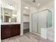 Bright bathroom with glass shower, a soaking tub, and a large vanity at 19740 W Sherman St, Buckeye, AZ 85326