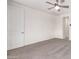 Bright carpeted bedroom with ceiling fan and adjacent bathroom access at 19740 W Sherman St, Buckeye, AZ 85326