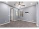 Inviting bedroom with soft gray walls, plush carpet, ceiling fan, and ample natural light at 19740 W Sherman St, Buckeye, AZ 85326