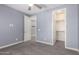 Bedroom with carpet, gray walls, closet, and an open doorway at 19740 W Sherman St, Buckeye, AZ 85326