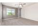 Cozy carpeted bedroom with ceiling fan and gray accent wall at 19740 W Sherman St, Buckeye, AZ 85326