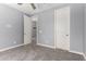 Bedroom with carpet, a ceiling fan, and open doorways, creating an open and inviting space at 19740 W Sherman St, Buckeye, AZ 85326