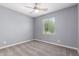 Cozy bedroom featuring neutral gray walls, plush carpeting, and a ceiling fan for added comfort at 19740 W Sherman St, Buckeye, AZ 85326
