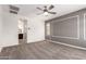 Spacious carpeted bedroom with ceiling fan, and en suite bathroom at 19740 W Sherman St, Buckeye, AZ 85326