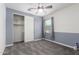 Bedroom with a soft gray palette, closet, and a light ceiling fan at 19740 W Sherman St, Buckeye, AZ 85326