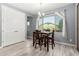 Bright dining area with wood table set, stylish lighting, and tiled floor next to a large storage closet at 19740 W Sherman St, Buckeye, AZ 85326