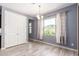 Bright dining room with natural light, modern light fixture, and hardwood flooring at 19740 W Sherman St, Buckeye, AZ 85326