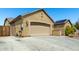 Spacious driveway leading to a two-car garage, complemented by desert landscaping at 19740 W Sherman St, Buckeye, AZ 85326