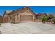 A beige-colored, two-car garage with a concrete driveway and stucco exterior features at 19740 W Sherman St, Buckeye, AZ 85326