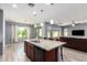 Open-concept kitchen with granite countertops, a large island, and stainless steel appliances at 19740 W Sherman St, Buckeye, AZ 85326