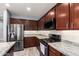Modern kitchen featuring stainless steel appliances, granite countertops, and wooden cabinets at 19740 W Sherman St, Buckeye, AZ 85326