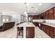 A kitchen with granite countertops, stainless steel appliances, and a large island with bar seating at 19740 W Sherman St, Buckeye, AZ 85326