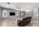 Bright living room with hardwood floors, ceiling fan, and media center ready for entertaining at 19740 W Sherman St, Buckeye, AZ 85326