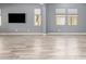 Bright living room with tile floors, neutral walls, and three large windows at 19740 W Sherman St, Buckeye, AZ 85326