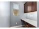 Efficient office space with built-in dark wood cabinetry, a desk, natural light from the window at 19740 W Sherman St, Buckeye, AZ 85326