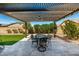 Inviting outdoor patio featuring a dining set under a shaded pergola, perfect for alfresco meals at 19740 W Sherman St, Buckeye, AZ 85326