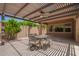 Inviting outdoor patio with pergola, fan, and dining set for enjoying outdoor meals at 19740 W Sherman St, Buckeye, AZ 85326