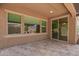 Covered patio featuring tile flooring, multiple windows, and a sliding glass door at 19740 W Sherman St, Buckeye, AZ 85326