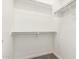 Walk-in closet featuring carpeted floors and built-in shelving at 19740 W Sherman St, Buckeye, AZ 85326
