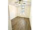 Bedroom with wood-look floors, a ceiling fan, and a large arched window at 20917 N 37Th Pl, Phoenix, AZ 85050