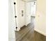 Bright hallway with wood-look floors and a storage cabinet by an open doorway to a bedroom at 20917 N 37Th Pl, Phoenix, AZ 85050