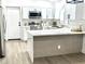 Bright kitchen featuring white cabinets, stainless steel appliances, and a quartz countertop island at 20917 N 37Th Pl, Phoenix, AZ 85050