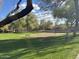 Scenic view of a neighborhood park with lush grass, trees, and a sand volleyball court at 20917 N 37Th Pl, Phoenix, AZ 85050