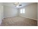 Spacious carpeted bedroom with a ceiling fan and natural light from a window at 2150 W Alameda Rd # 1122, Phoenix, AZ 85085